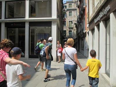 11 photos show crowded streets and alleys 8 to 20 feet wide between 3- and 4-story buildings.